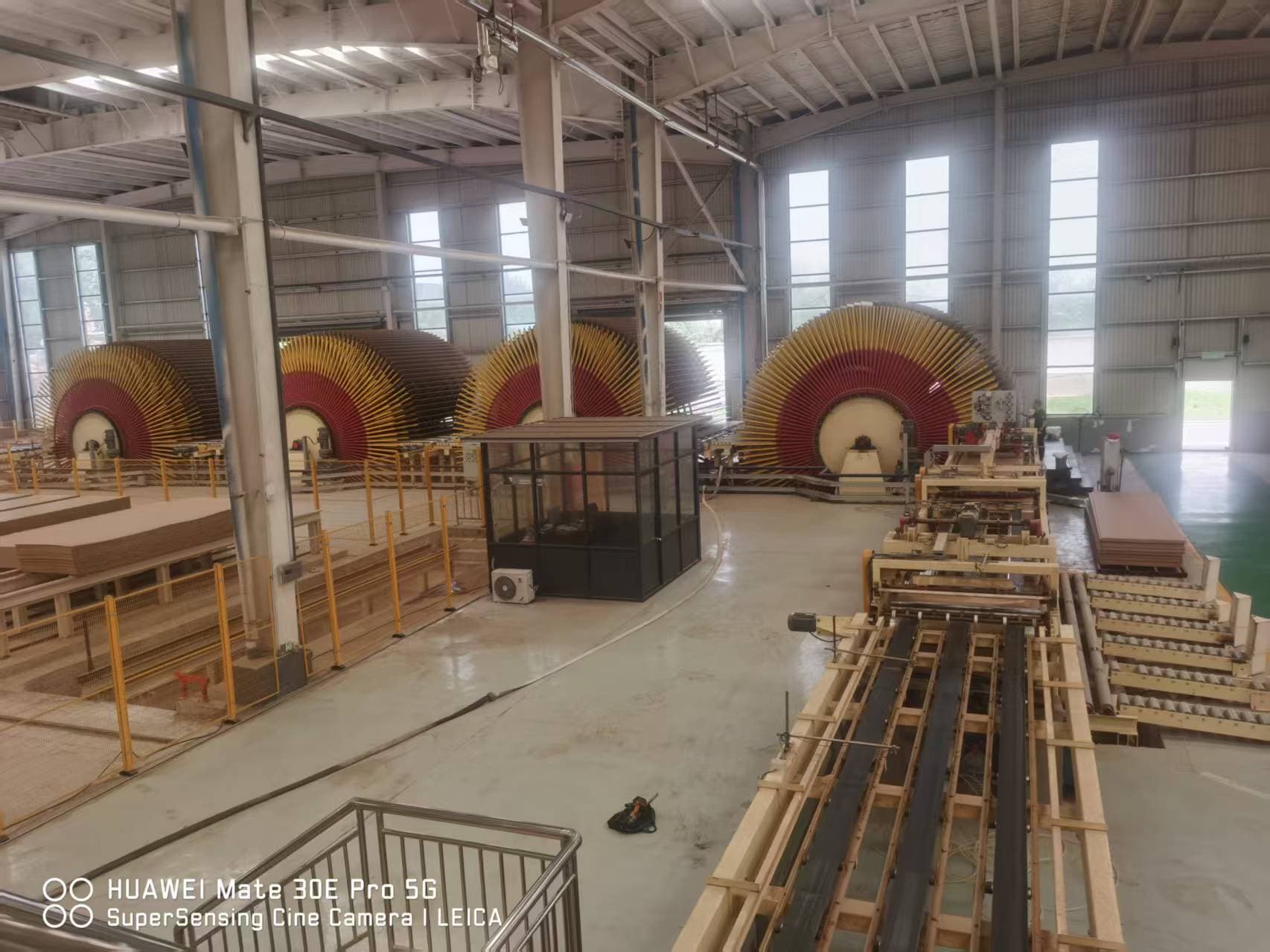 Board-handling equipment and stacked panels inside the CUZI MDF workshop
